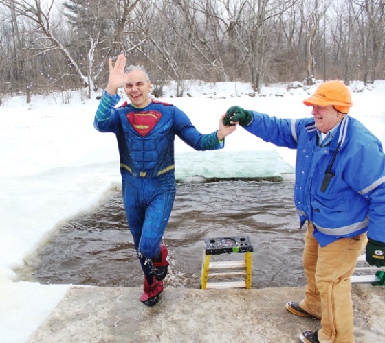 Marathon County Administrator Brad Karger being helped out of the water by Gary Beastrom, event volunteer and County Board Member.